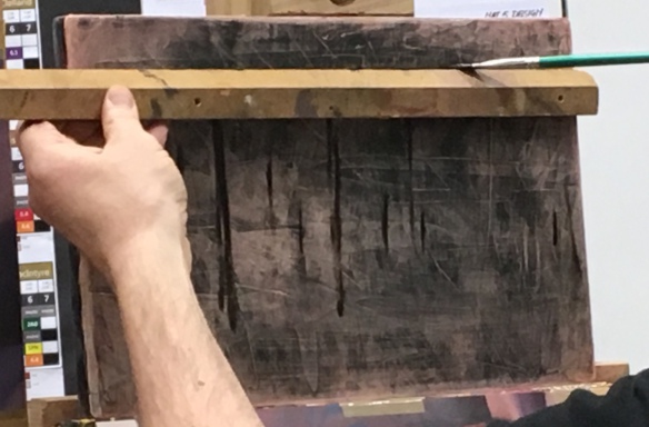 Andrew then uses a stick to paint in vertical lines and horizontal lines in the still Life